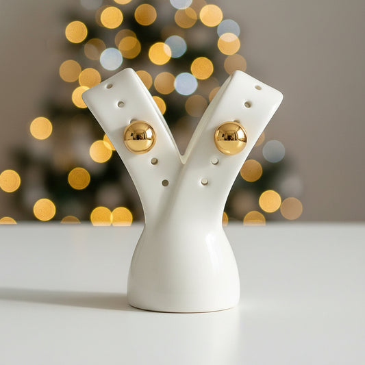 Gold stainless steel earrings on a white card with 'Stainless steel' text.