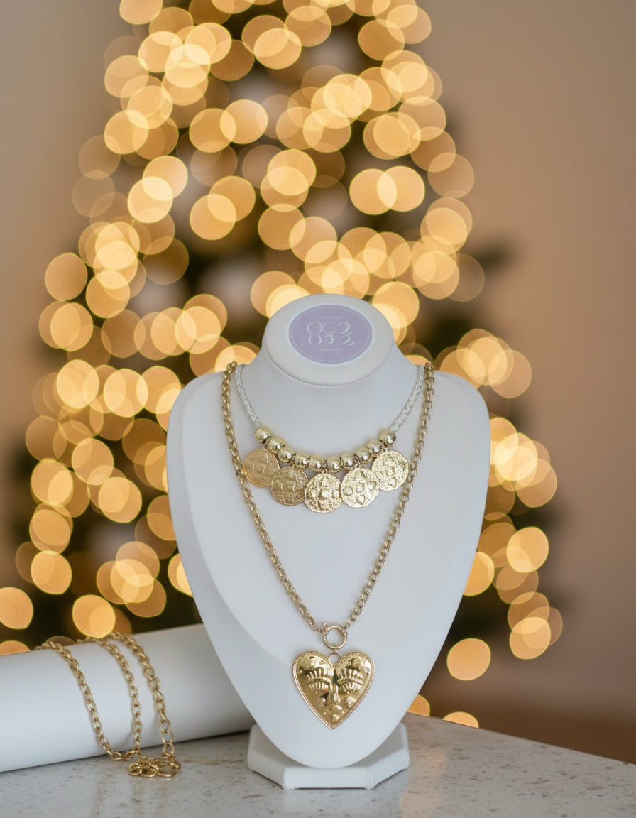 Gold necklace with heart pendant on a mannequin bust