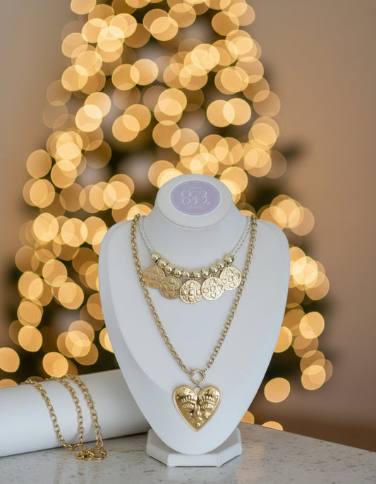 Gold necklace with heart pendant on a mannequin bust